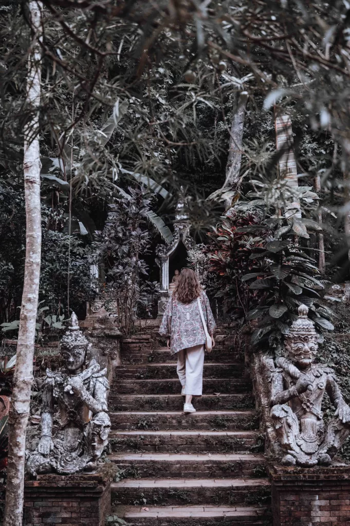 Climbing the stairs of Wat Pha Lat.